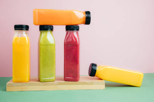 istock Fruit and vegetable smoothies in transparent plastic bottles. Green, red, orange smoothies on a pink-green background. The concept of healthy eating 2139971533