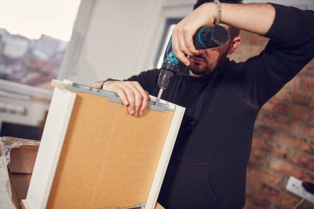 istock Man working and assembling furniture in a new apartment. 2139978457