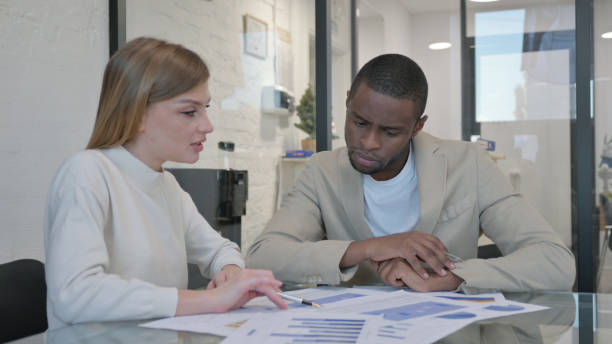 istock Young Mixed Race People Doing Paperwork in Office 2139992793