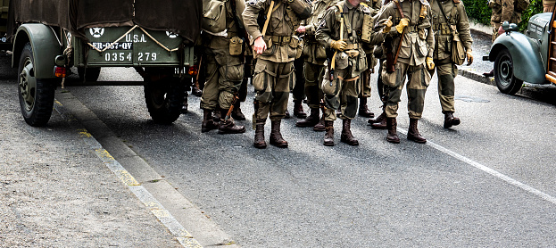 Second world war commemoration. Military camp reconstitution. Unidentified armed troop soldiers walking after liberation