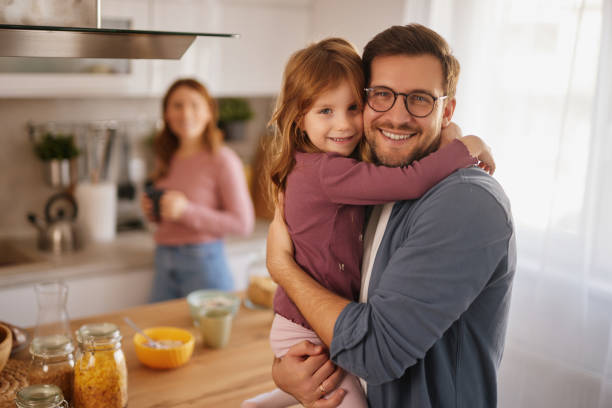 istock Happy family having breakfast at table in kitchen 2140023656