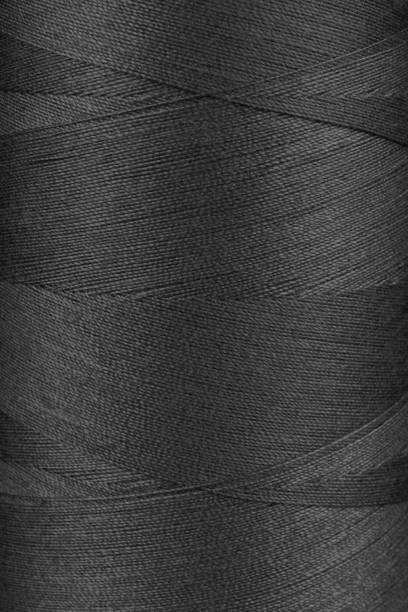 istock Texture of black color threads in spool close up, macro 2140023888