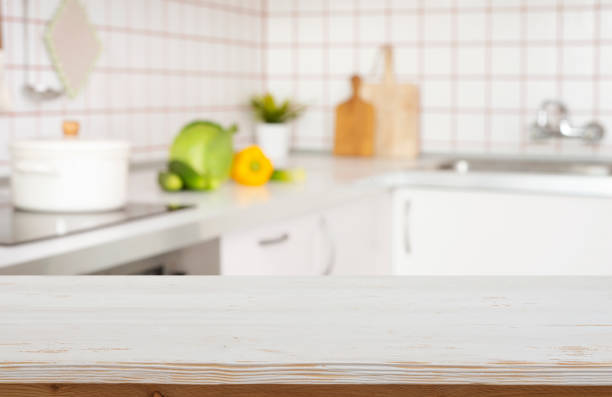 istock Empty wood table top counter ready for product montage and blur modern kitchen interior background 2140055265
