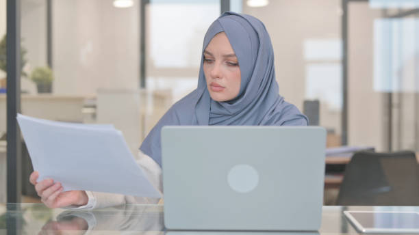 istock Arab Woman Working on Documents and Laptop 2140078332