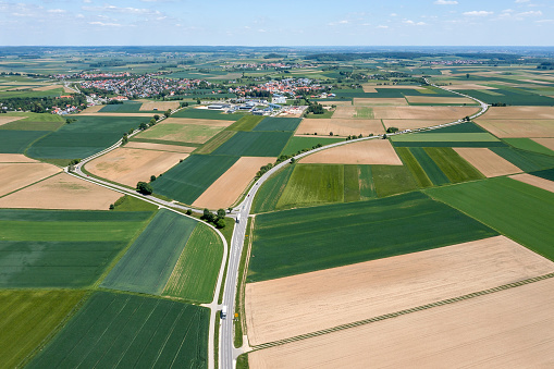 Aerial view of roads with traffic in a beautiful rural, spring landscape.