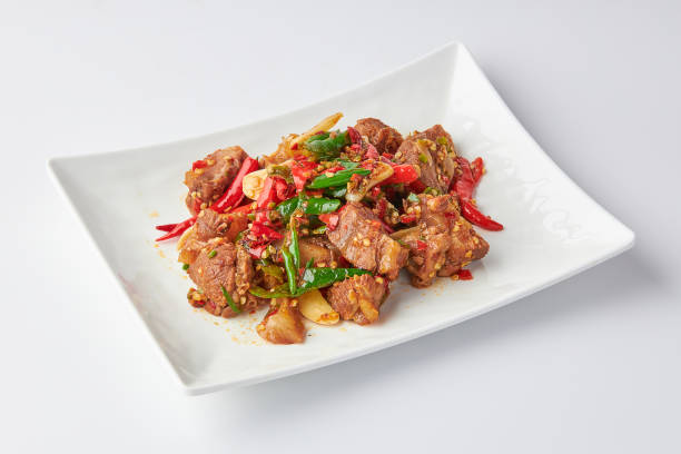istock Stir-fried stewed beef shank with holy basil , chili and garlic served on white plate isolated on white background. Stir-fried holy basil is a very popular food in Thailand. 2140131375