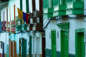 Range of multi-colored facades in Jerico, Jericó, Antioquia, Colombia. Colombian flag.