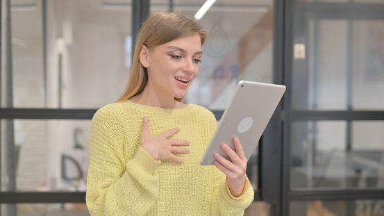 Portrait of Blonde Young Woman Talking for Chat on Tablet