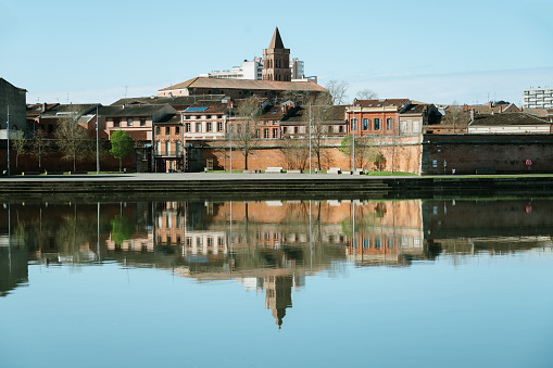 Toulouse reflected on the Garonne river. Saint Cyprien area