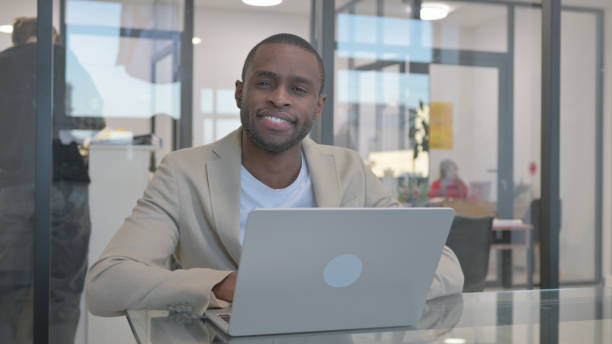 istock Thumbs Up by African Businessman at Work 2140172950