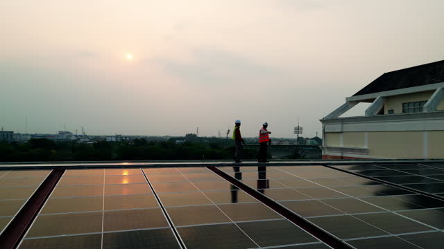 Two men standing on a solar panel