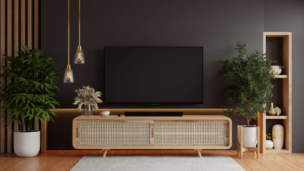 istock Mockup a TV wall mounted in a dark room with a black wall 2140187897