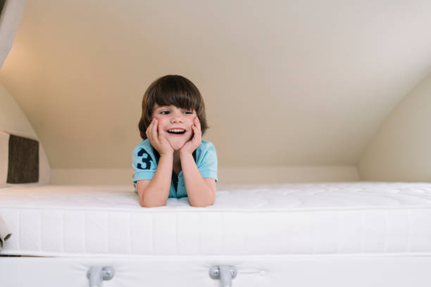 Little boy playing in the caravan bed