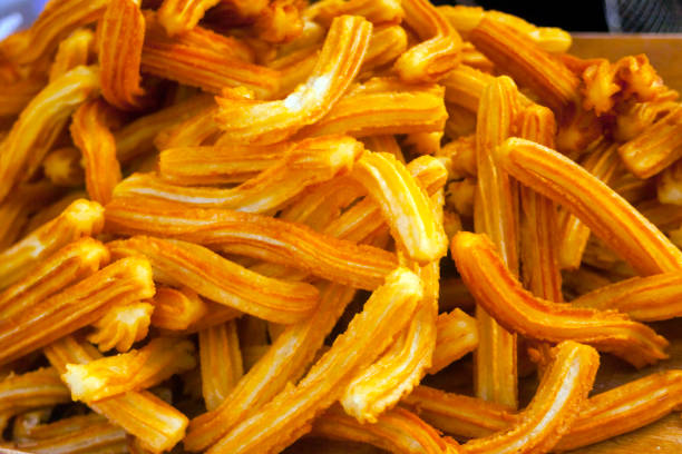 Heap of churros, full frame view suitable for background purposes. Spanish culture.Lugo city, Galicia, Spain during San Froilán autumn traditional celebrations.