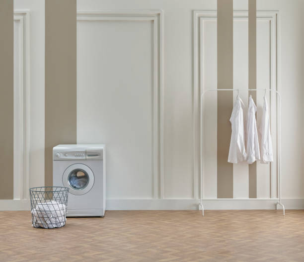 istock Washing dryer machine and ironing table interior style, laundry room, white and brown vertical wall background. 2140217048