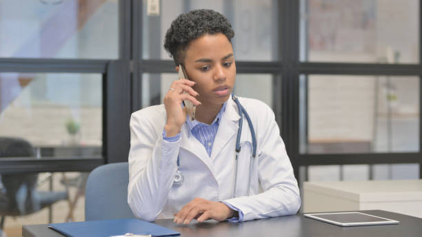 istock Mixed Race Female Doctor Talking on Phone 2140219693