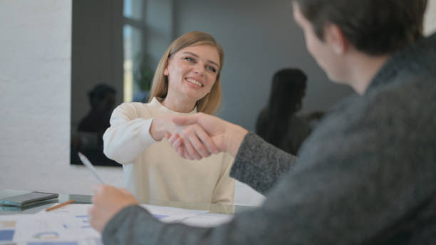 istock Confident Young Woman Shaking Hand with Partner 2140232356