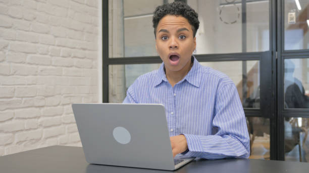 istock Shocked African Woman Looking at Camera in Office 2140239556
