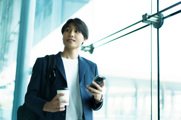 istock Asian young businessman walking in the terminal. 2140243254