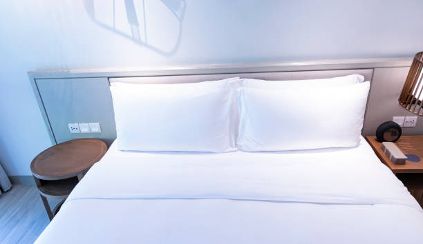 istock white pillows on the bedroom on a bed with duvet case bedspread isolated on white background 2140254426