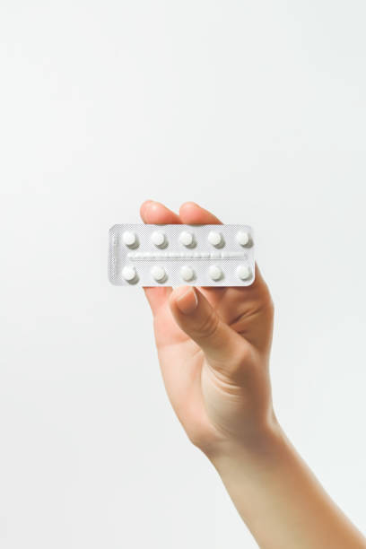 istock hand holding a blister with white pills on a white background 2140265501