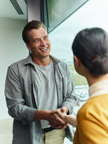 Bizarre cross-eyed businessman came to an agreement with his female colleague at casual office.