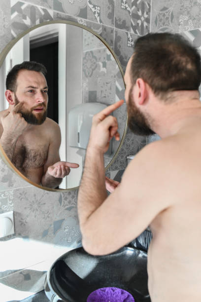 istock Male Applying Skincare Cream On Face 2140277943