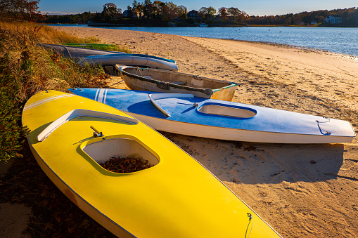 Onset Beach Seascape with weathered kayaks on the sand in Wareham, Massachusetts, USA