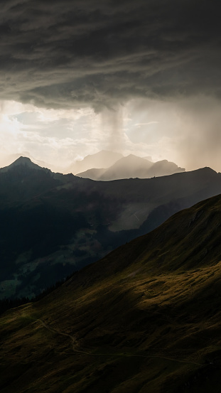 A dramatic sky with dark clouds over mountain peaks