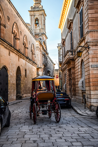 Horse Carriage Traversing Streets Next To St. Paul's Cathedral In Mdina, Malta