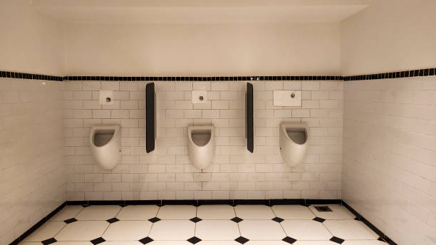 istock Empty male toilet with warm light 2140297077