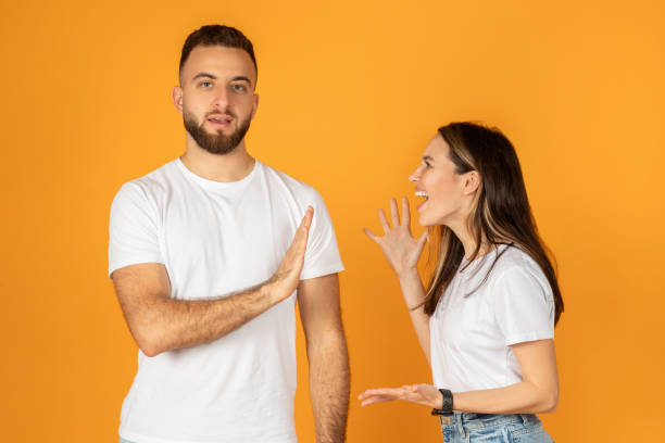 istock A man in a white shirt shows a stop gesture with his hand while a woman 2140305196