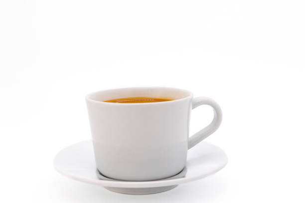 istock Creamy coffee on a white porcelain cup, isolated on white background with copy space. Side view, close-up. 2140321363