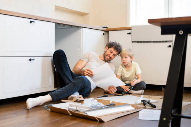 istock Father and son assembling kitchen furniture 2140376917