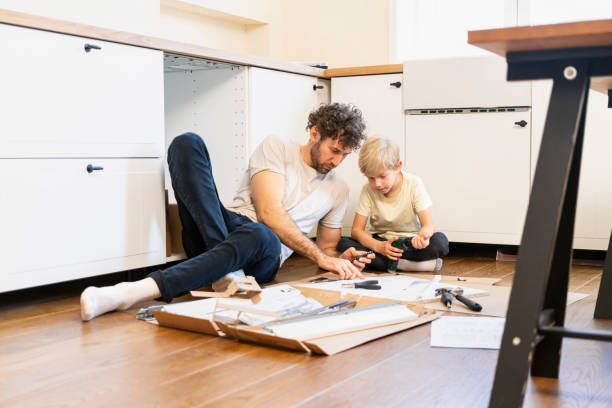 istock Father and son assembling kitchen furniture 2140377963