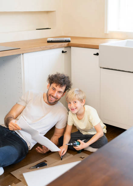 istock Father and son assembling kitchen furniture 2140379537
