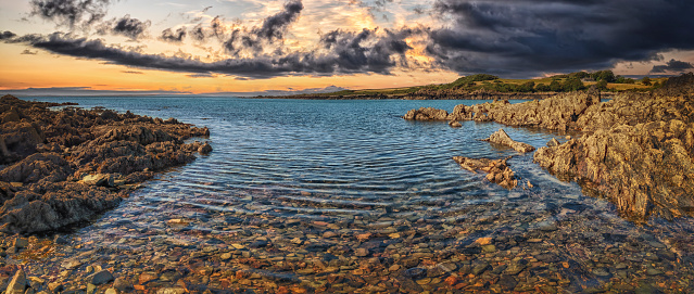 Dark cloudy sky during sunset over water at Isle of Whithorn, Scotland, United Kingdom