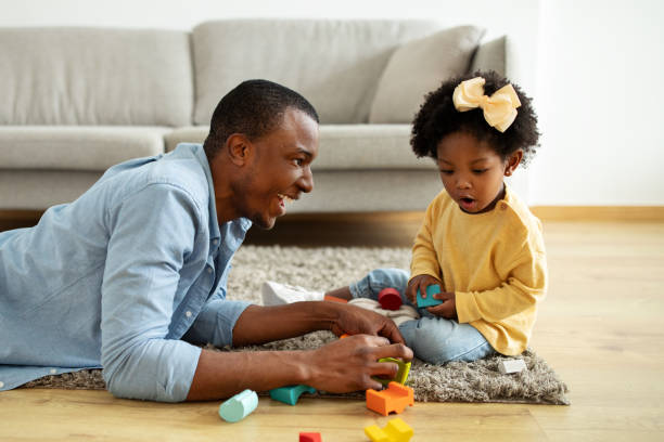istock Beautiful little black girl enjoying time with her daddy 2140404861