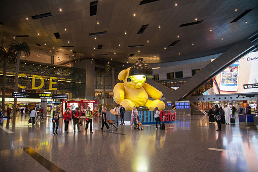 Doha, Qatar - October 12 2019: Hamad International Airport Terminal with all gates and Travellers passing.