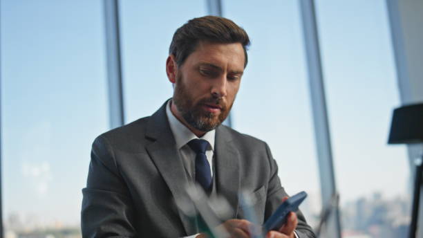 istock Busy professional checking smartphone messages. Closeup hands signing documents 2140418786