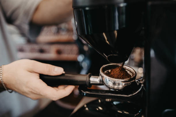 istock barista grinding coffee in a coffee machine 2140421970