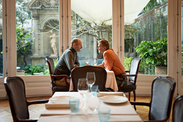 istock Male couple enjoying white wine during daytime date 2140424650