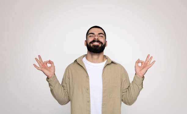istock A man with a full beard and a beaming smile makes the 'okay' sign with both hands 2140480305