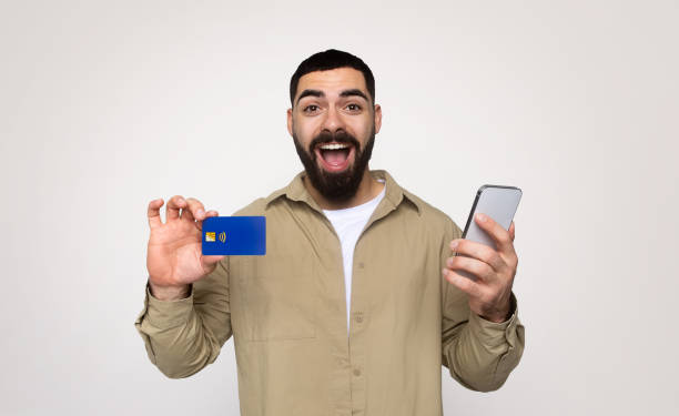 istock Glad shocked young middle eastern guy shopaholic with beard in casual with open mouth 2140481463