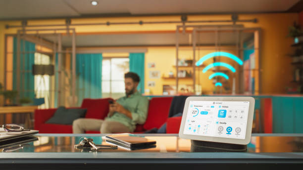 istock Creative Smart Home Device with Infographics Shown on Display and Icons Around Display. Person using Smartphone to Control His Stylish Apartment. IOT High-Tech Connected Wireless Intelligent System 2140493037