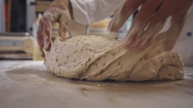 Baker hand knead raw dough close up. Bread bakery. Man cook loaf at baking house