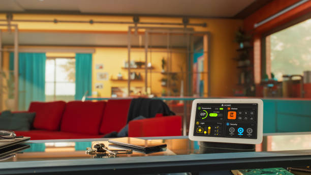 istock Creative Smart Home Device with Infographics Shown on Display Standing On The Table In Stylish Tastefully Decorated Apartment. Concept of IOT High-Tech Connected Wireless Intelligent System. 2140493659