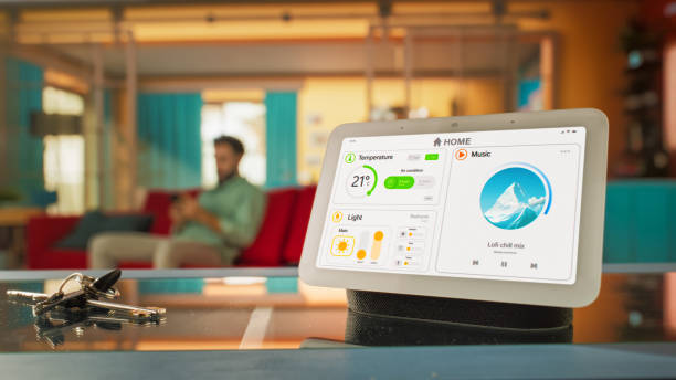 istock Creative Smart Home Device with Light Theme Infographics Shown on Display and Icons With Functions. Person using Smartphone to Control Stylish House. IOT Connected Wireless Intelligent System 2140495275