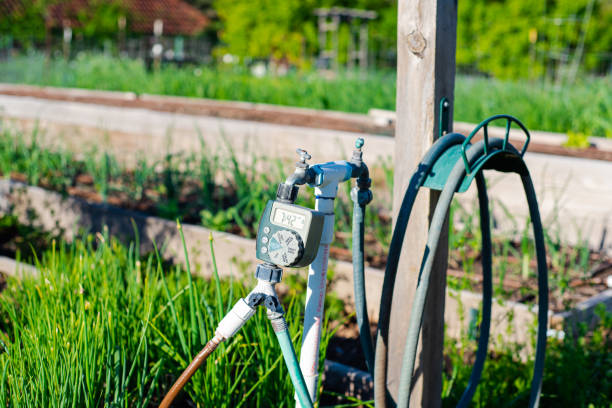 istock Water station at community garden, hose hanger, digital timer, large display controls, PVC pipe, outlet hose faucet Y splitter connector automate drip irrigation system, water energy conservation 2140495873