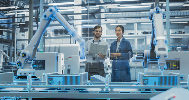 istock Electronics Factory Digitalization: Automated Robot Arm Assembly Line Manufacturing Advanced Equipment. Managers Discussing Work while Futuristic AI Computer Vision Analyzing, Scanning Production Line 2140495878